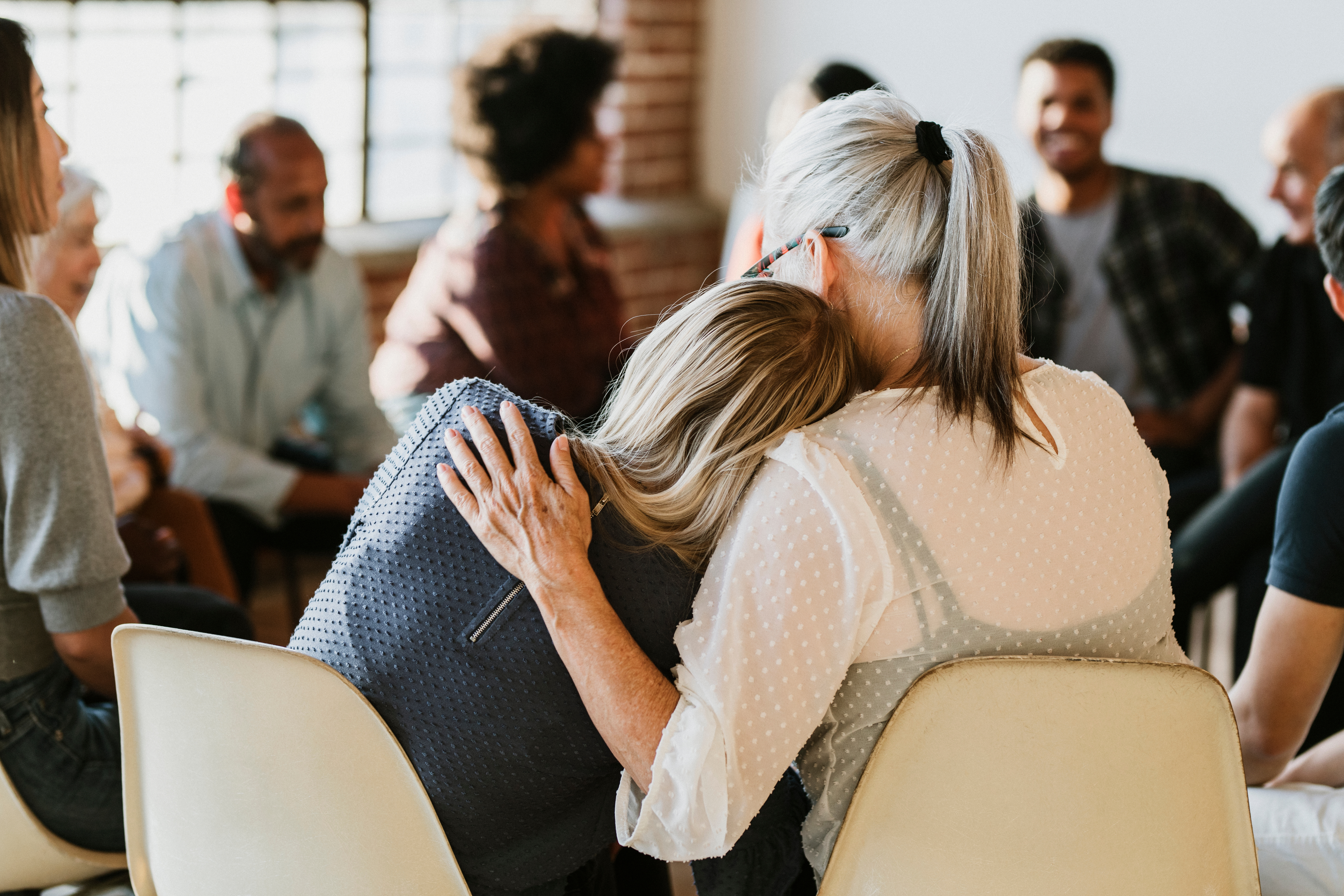 Support group consoling hug