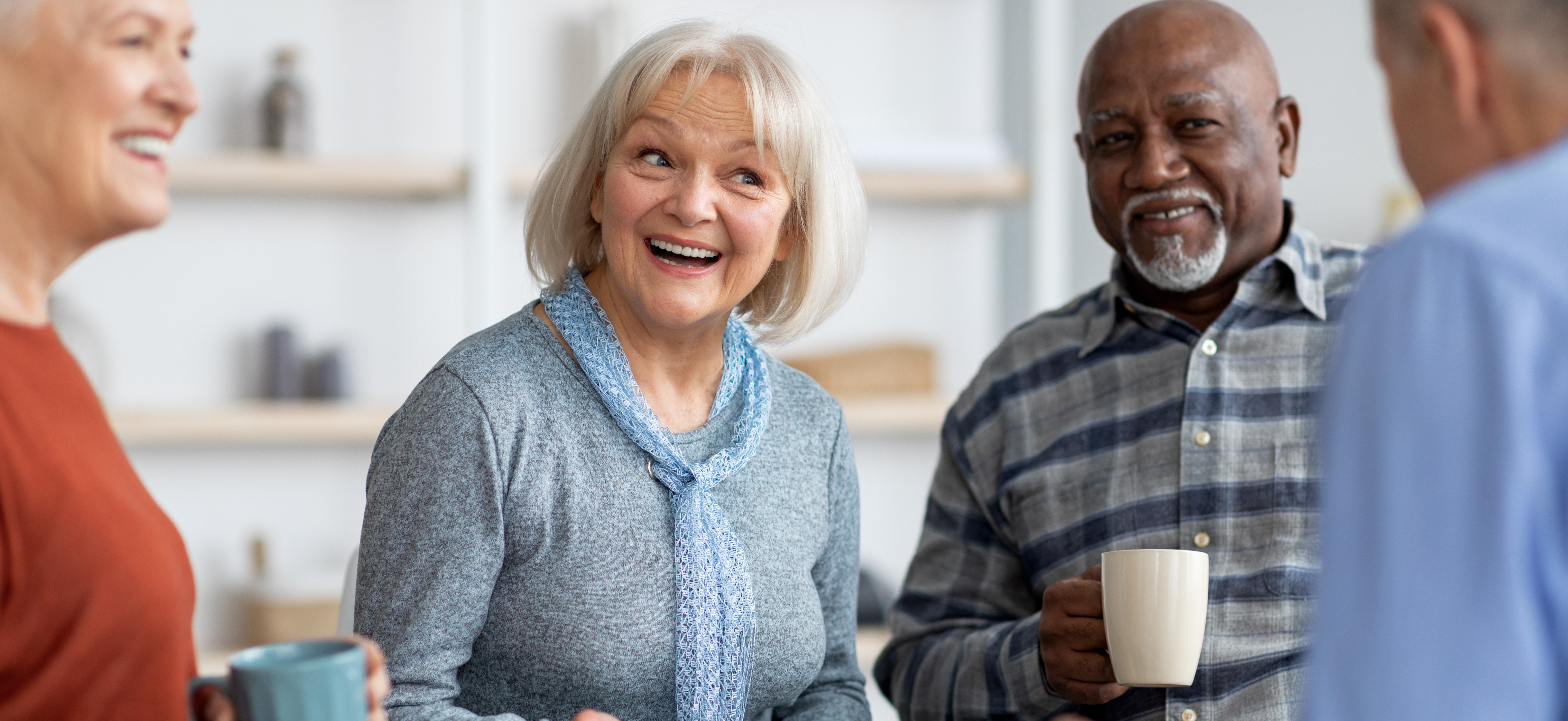 Volunteer Group smiling and drinking tea
