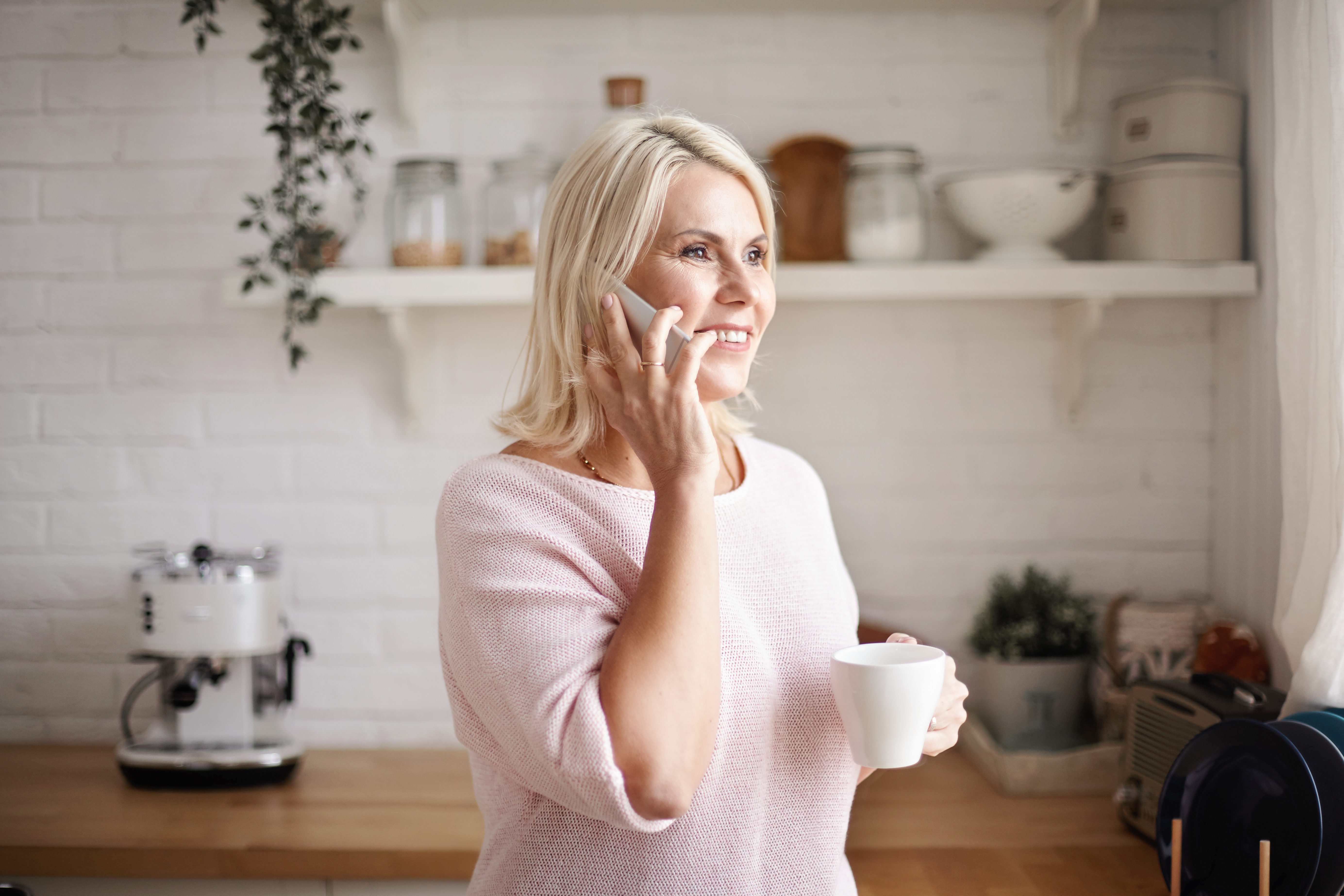Middle aged woman on phone smiling