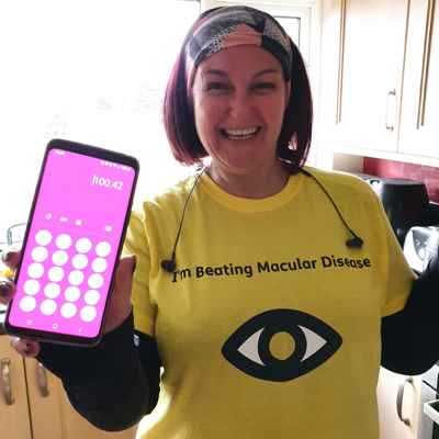 Step Around the World - Lisa Fisher in Macular Society t-shirt with phone