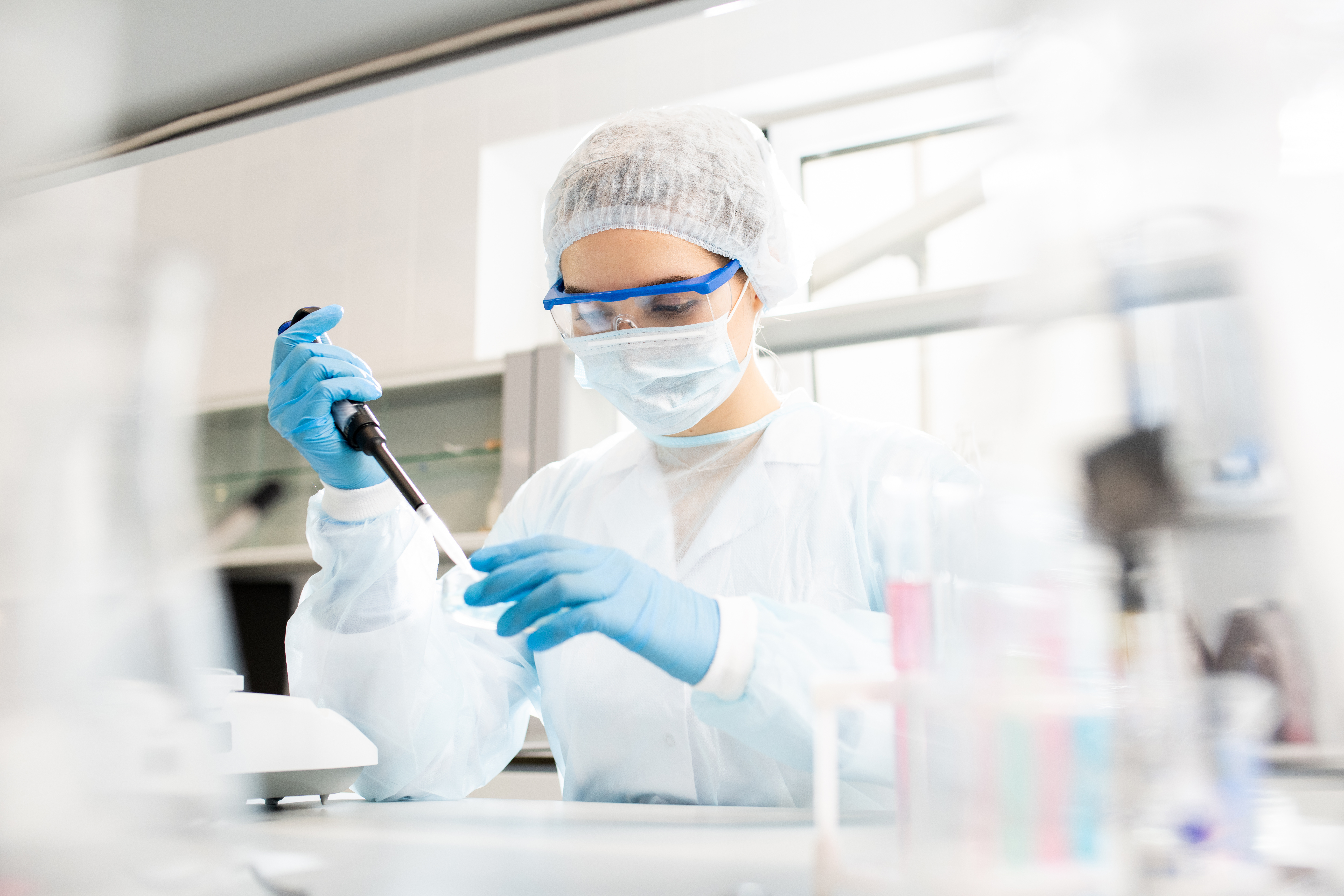 Researcher working in mask, gloves, goggles